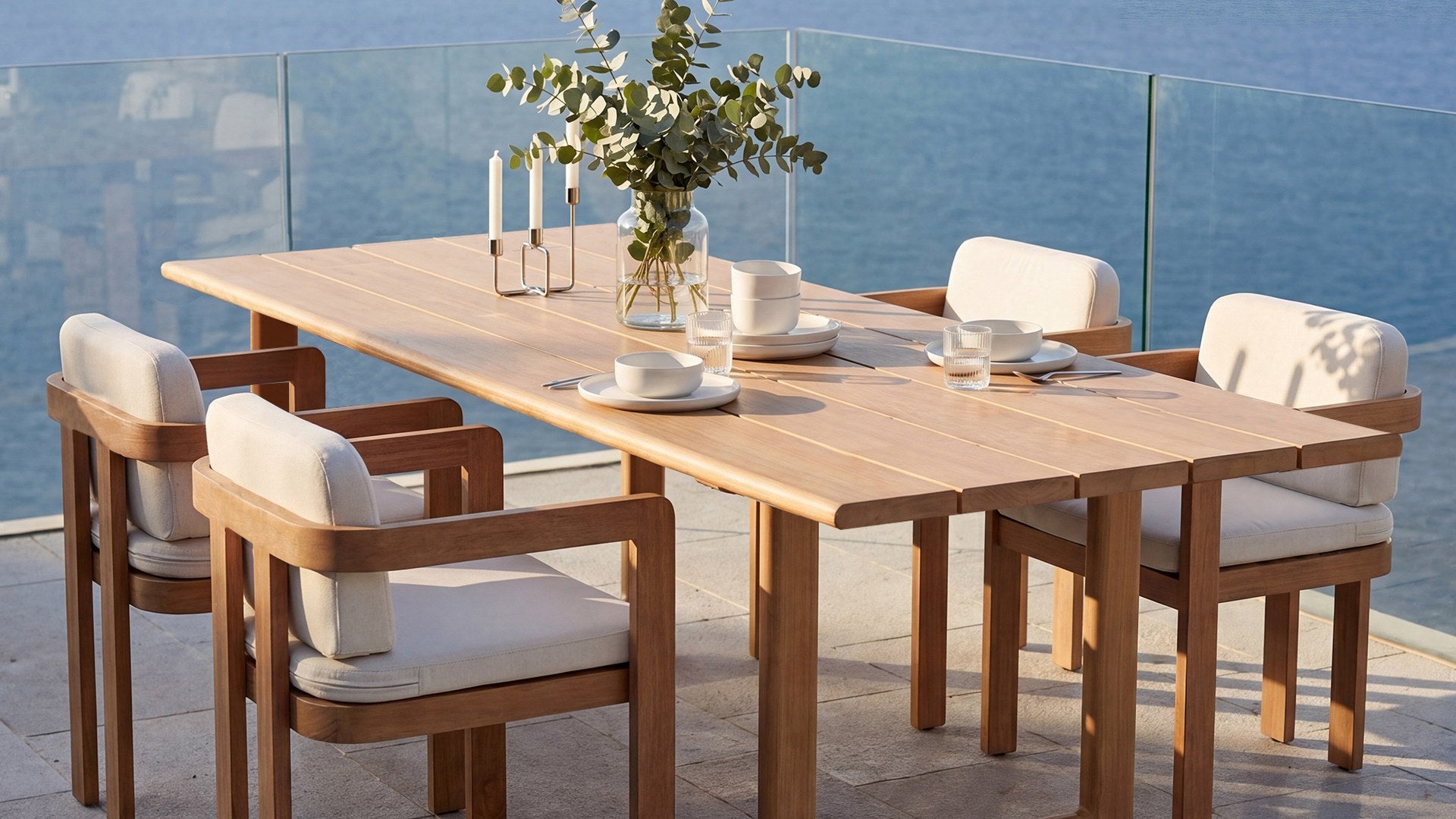 DALA dining table and armchairs on a seafront terrace · Natural Wood